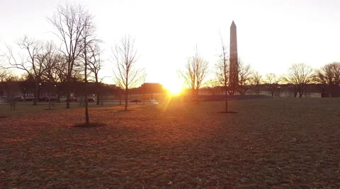 Walking through Constitution Gardens facing The Washington Monument Stock Footage 62872498