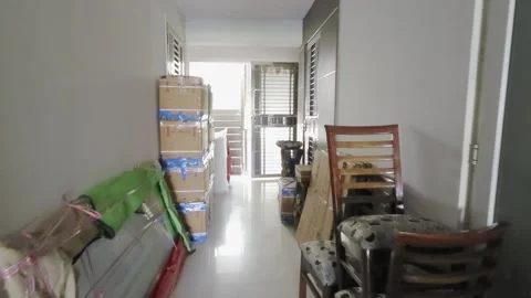 Walking through corridor filled with boxes cartons furniture and home items as a Stock Footage 333009910