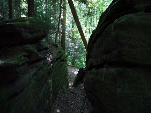 Walking through crevice between two large rock formations Stock Footage 82665650