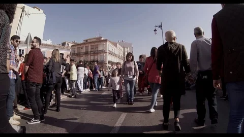 Walking through the crowd on a street during an outdoor event or parade Stock Footage 107443356