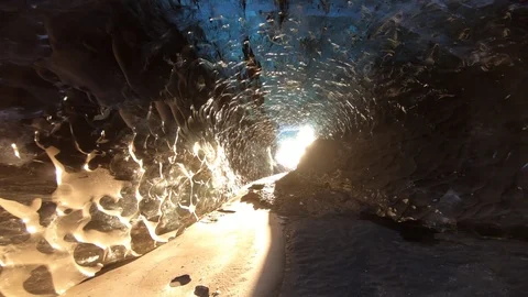 Walking through dark ice caves in Iceland glacier Stock Footage 122297024