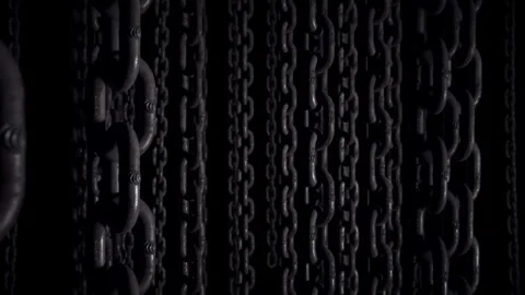 Walking through a dark space with chains hanging from the ceiling. Vídeos de archivo 336400862