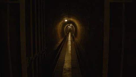 Walking through a dimly lit underground tunnel  Stock Footage 301030824