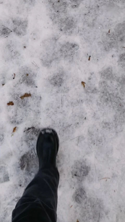 Walking through dirty melting snow. Stock Footage 329910343