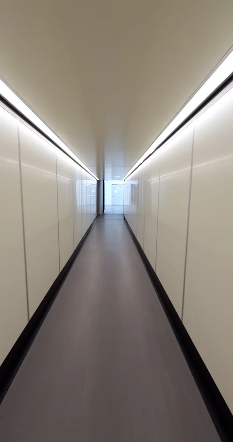Walking through empty airport jetway from arrived plane, POV vertical shot Stock Footage 297053762