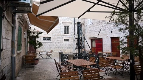 Walking through empty restaurant tables in Kotor, Montenegro Stock Footage 341994660