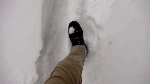 Walking through fresh city snow, Bootprints fade into soft winter powder Stock Footage 328090129