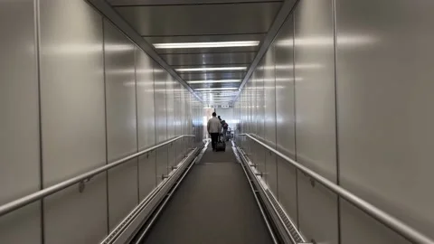 Walking through gate onto ramp to board a plane, new adventures 스톡 동영상 170911304