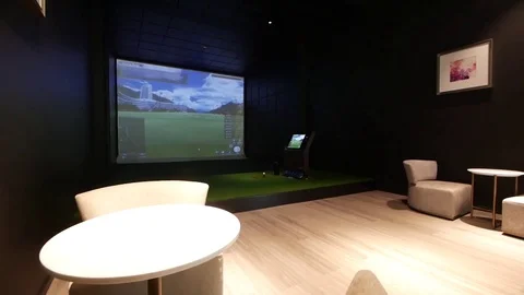Walking Through the Golf Simulator Room decorated with the cosy armchairs Stock Footage 121810525