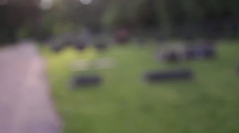 Walking through graveyard, going in and out of focus Stock Footage 27478812