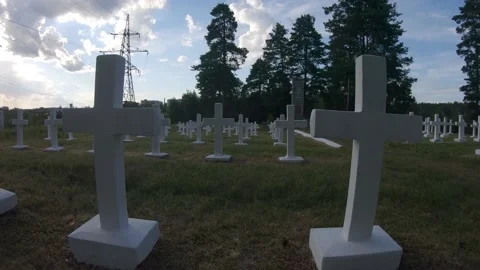 Walking through a Graveyard of White Crosses for Fallen Soldiers 4k60fps Stock Footage 135636003
