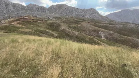 Walking Through Highland Grass Toward Mountain Landscape Stock Footage 343831306