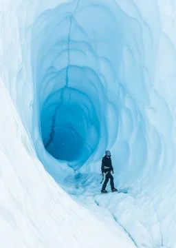 Walking through an ice cave on the Matanuska Glacier in Alaska. Stock Photos