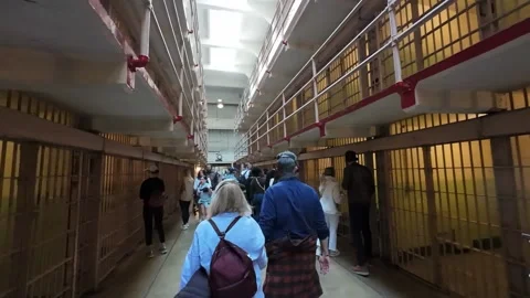 Walking Through the Main Cell Block of a Historic Prison Stock Footage 327920896