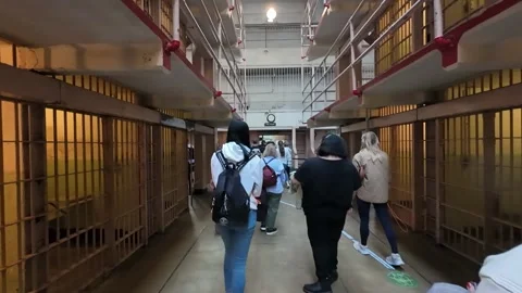 Walking Through the Main Cell Block Corridor of a Historic Prison Stock Footage 328128844