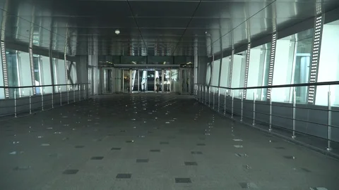 Walking through a modern empty corridor in airport terminal Stock Footage 117174699