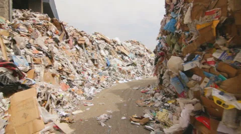 WALKING THROUGH MOUNTAINS OF RECYCLABLES Stock Footage 6526975