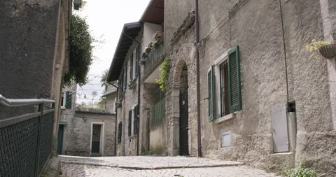 Walking through narrow authentic streets in Italy. Narrow street Lake Como Stock Footage 288078289