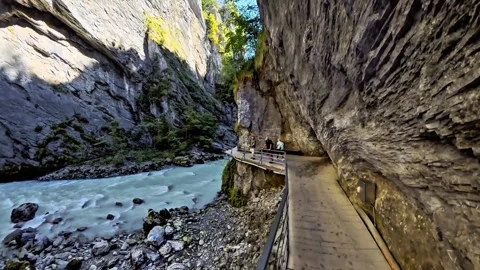 Walking Through Narrow Gorge Beside Turquoise River Stock Footage 344878266