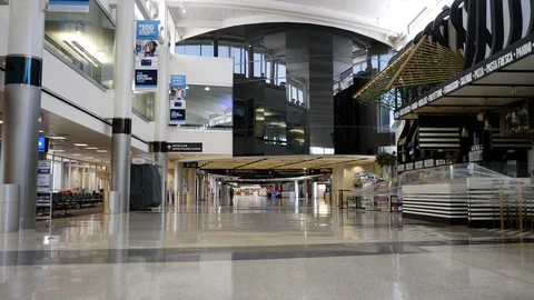 Walking through nearly empty airport terminal Stock Footage 129345186