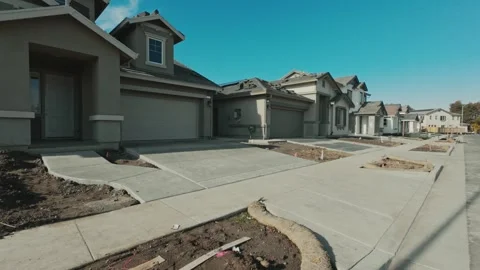 Walking through new house development under construction Stock Footage 295006898