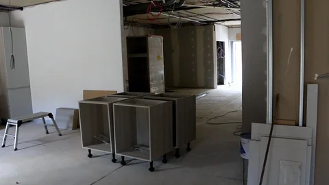 Walking through an office under construction with half built furniture Stock Footage 112651999