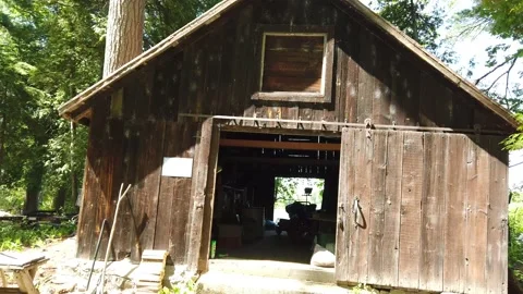 Walking through an old barn to the river 4K Stock Footage 133799489