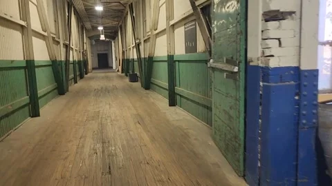 Walking through old industrial warehouse with wooden crates and cargo pallets Stock Footage 318565842