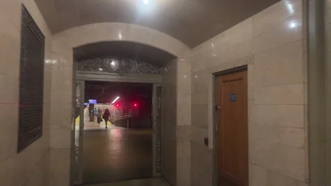 Walking Through Ornate Iron Gate to Near-Empty Grand Central Platform, Track 32 Stock Footage 347919285