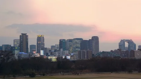 Walking through park Osaka Umeda skyline lights background winter Vídeo Stock 72579956