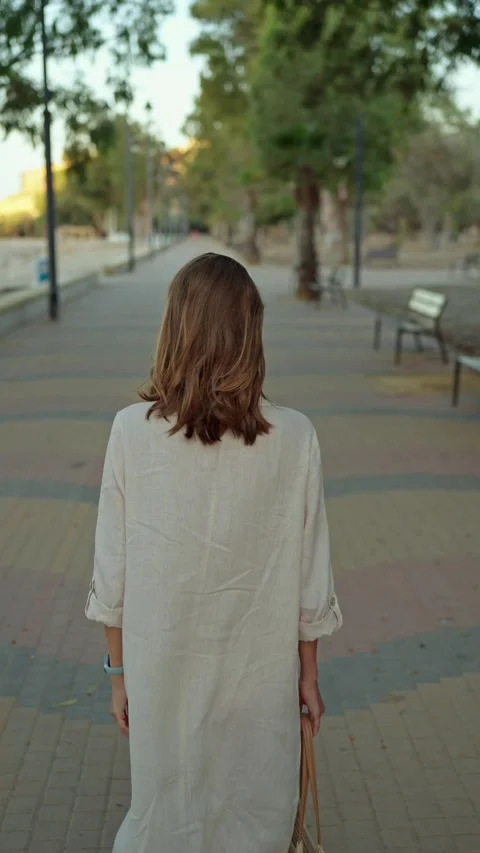 Walking through a park on a sunny day while leaving a peaceful space behind Stock Footage 342787076
