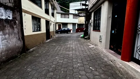 Walking through a paved street with old houses at both sides Stockbeeldmateriaal 336870805