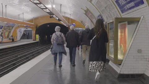 Walking through the platform of a Paris metro station, showcasing city life and Stock Footage 305755281