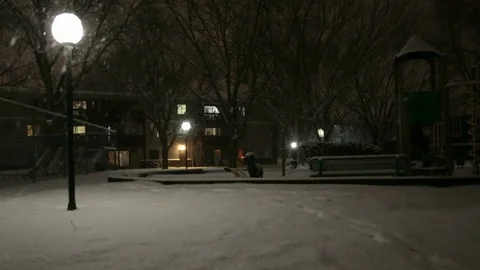 Walking through a playground during a snowstorm. Video stock 70768480