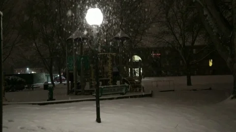 Walking through a playground during a snowstorm. Video stock 70824587