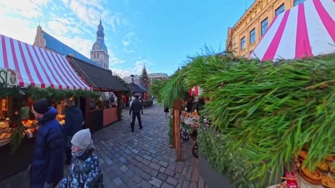 Walking through Riga’s holiday craft market with handmade goods, ornaments, and Stock Footage 327346434
