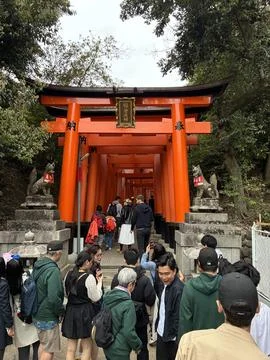 Walking through the rows of torii gates at Fushimi Inari-taisha shrine 写真素材