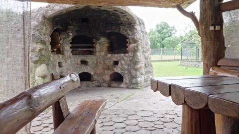 Walking Through Rustic Dining Area to Stone-Built Outdoor Cooking Area Video stock 278184929
