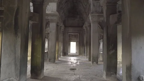 Walking through a section of Angkor Wat and looking up at the stonework Stock Footage 108439434
