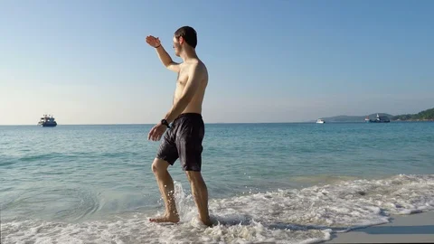 Walking Through Shallow Waves on Beautiful Tropical Beach Stock Footage 119559987