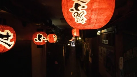 Walking through a small quiet street onto crowded Dotonburi street in Osaka Stock Footage 111983588