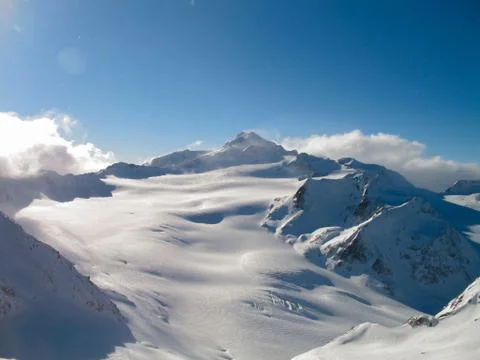 Walking through the snow-capped white mountains in a sunny day Foto stock