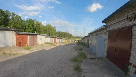 Walking Through a Soviet Garage Block with Energy Towers in Sight 4k60fps Stock Footage 135635926