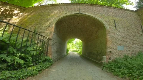 Walking through a stone gate in the woods in the daylight. Stock Footage 244588022