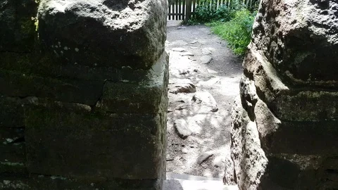 Walking Through Stone Wall Towards Gate Stock Footage 92630397
