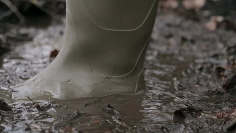 Walking through Thick Mud with Sturdy Rubber Boots Beautiful Nature Scene Stock Footage 305407243