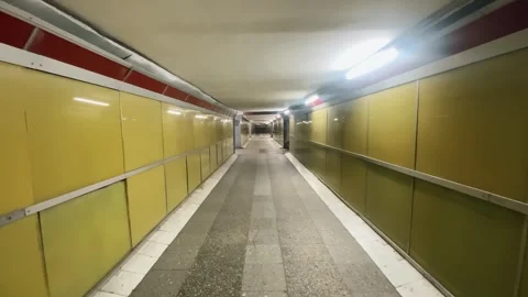 Walking Through a Yellow-Tiled Subway Tunnel in the Evening Video stock 278600851