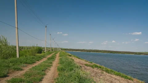 Walking timelapse over electricity poles near water Stock Footage 45599765