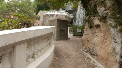 Walking on tiny bridge to waterfall and cave, Hong Kong park Stock Footage 49276459
