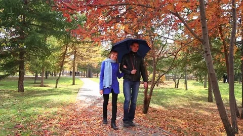 Walking together under umbrella Stock Footage 42707092
